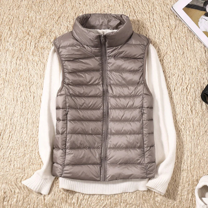 Close-up of women's quilted gilet showing horizontal padded channels and structured fit at the hip