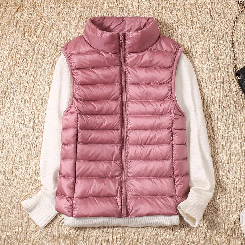 Women's puffer gilet with stand collar detail and smooth quilted outer shell in rose gold tone