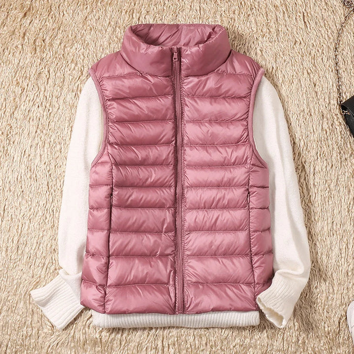 Women's puffer gilet with stand collar detail and smooth quilted outer shell in rose gold tone