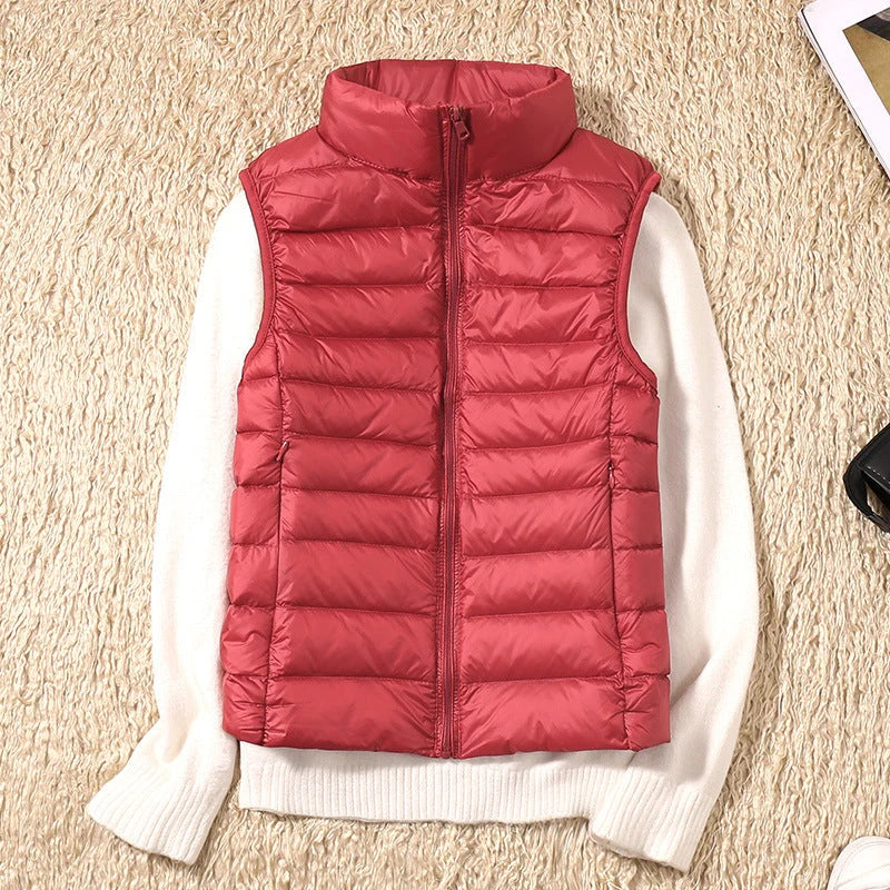 Flat lay of women's quilted gilet showing full-zip closure and sleeveless design with ribbed collar