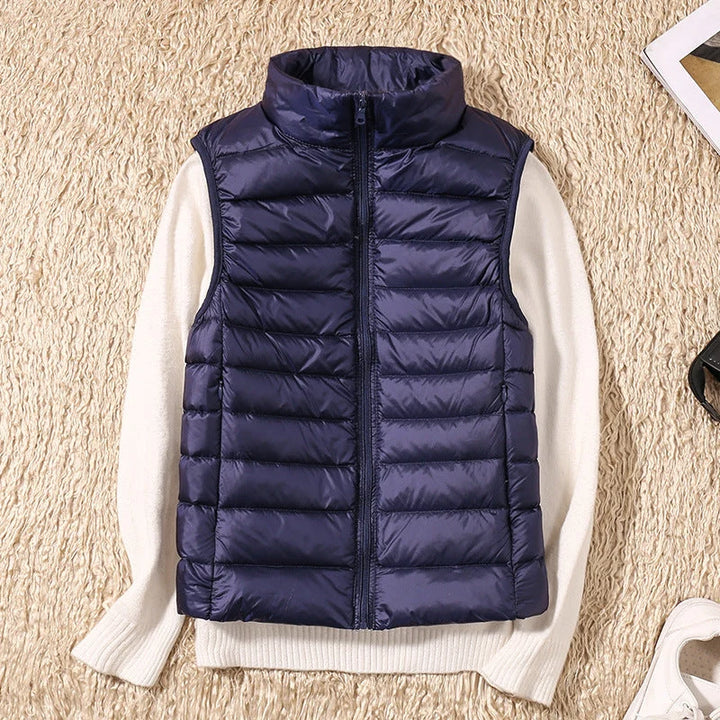 Back view of women's quilted gilet with horizontal quilted channels and fitted waist shape
