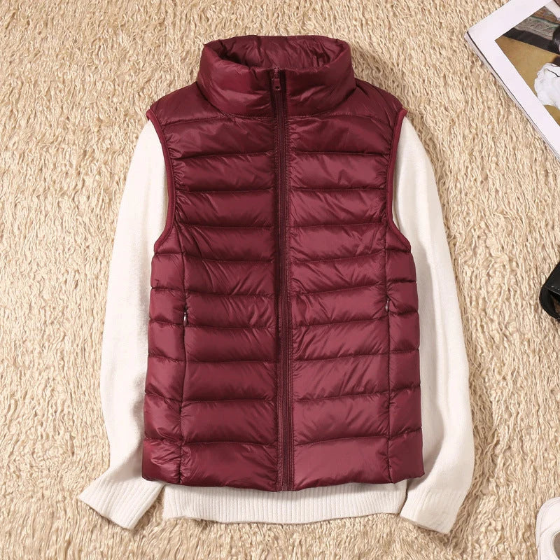 Women's sleeveless gilet in rose gold layered over white knitwear for casual autumn styling