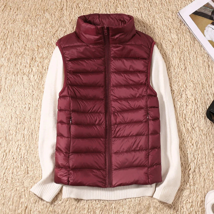Women's sleeveless gilet in rose gold layered over white knitwear for casual autumn styling