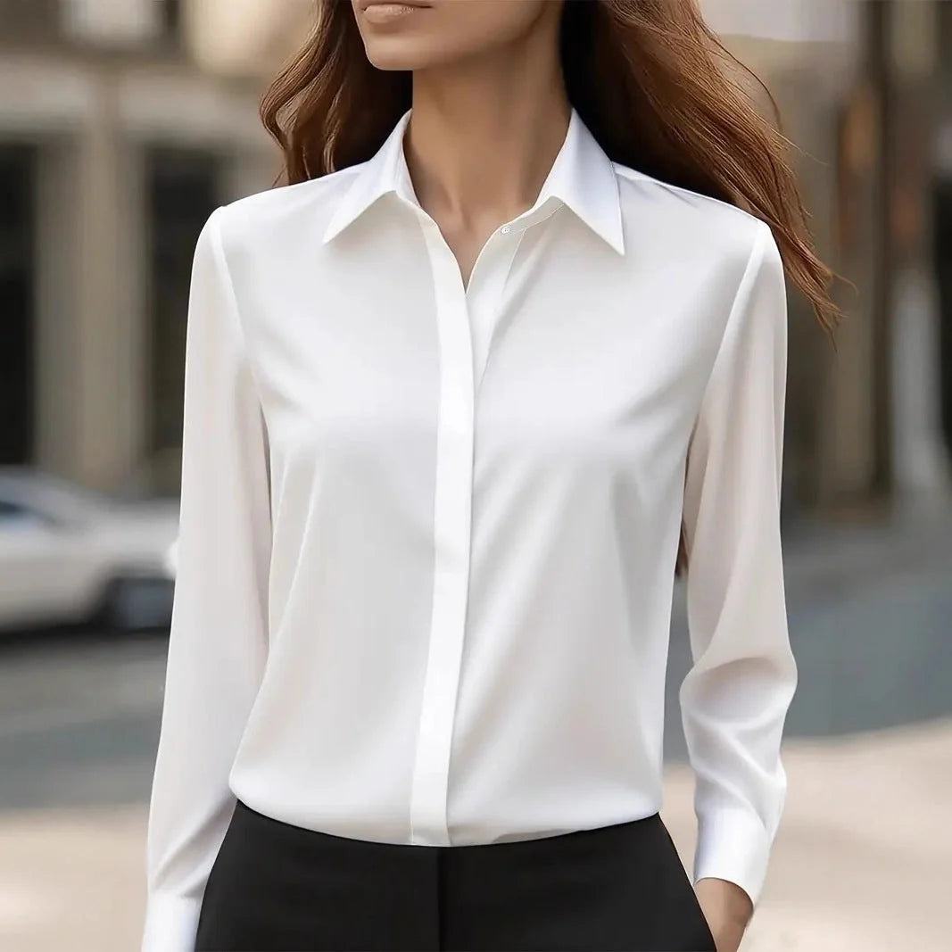 Close-up view of satin blouse showing smooth fabric drape and button-front closure detail