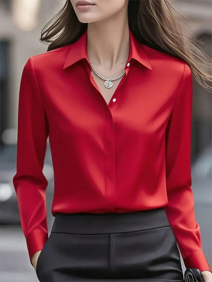 Detail of pointed collar and concealed button placket on satin blouse for women