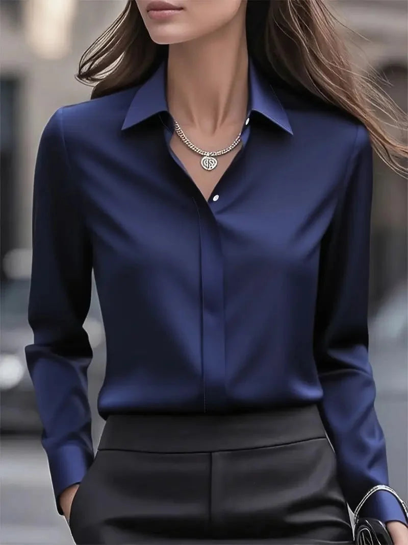 Satin blouse styled for smart-casual occasions with relaxed yet polished appearance