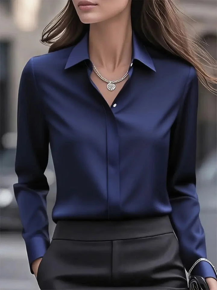 Satin blouse styled for smart-casual occasions with relaxed yet polished appearance