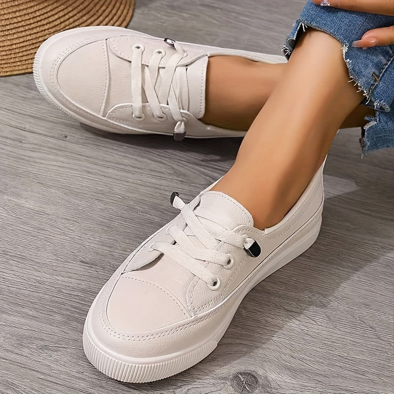 Full view of white lace-up trainers highlighting versatile casual footwear design
