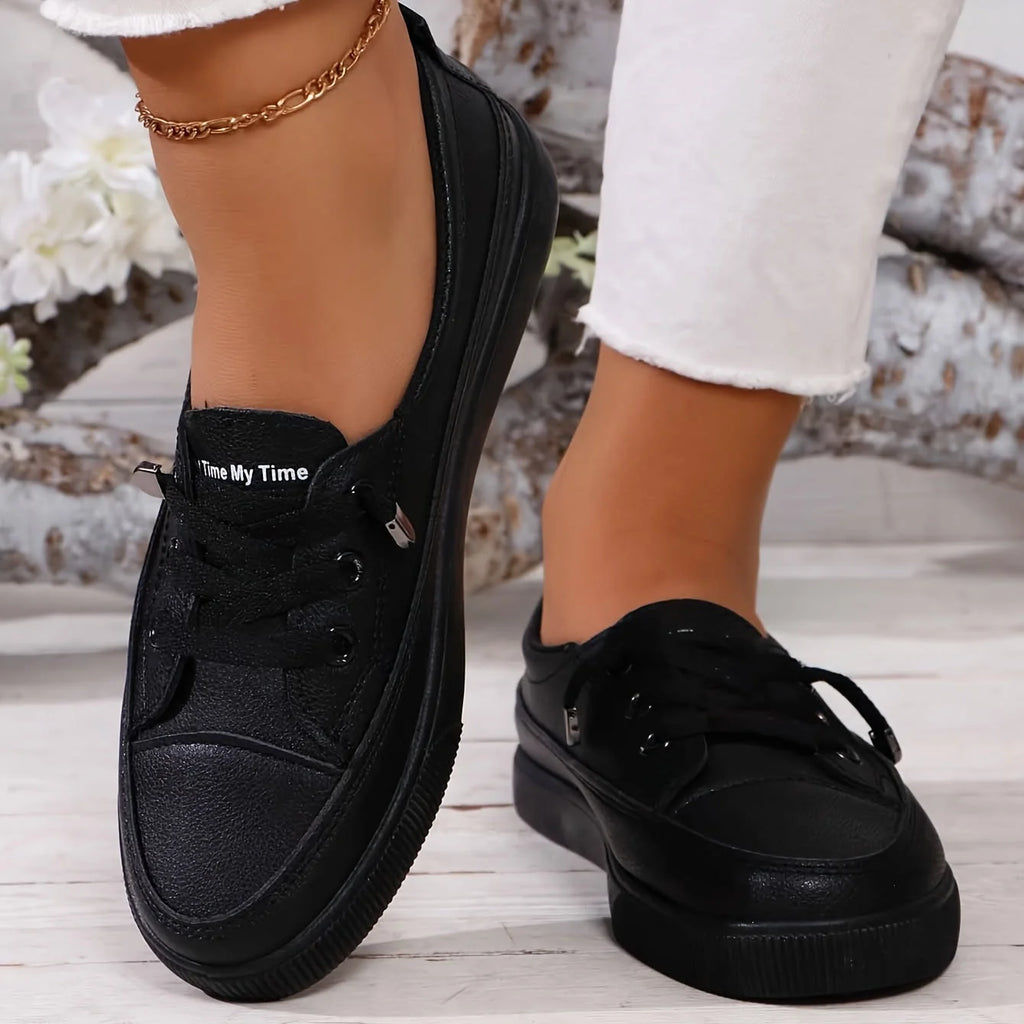 Top-down view of white trainers displaying lace-up closure and clean upper construction