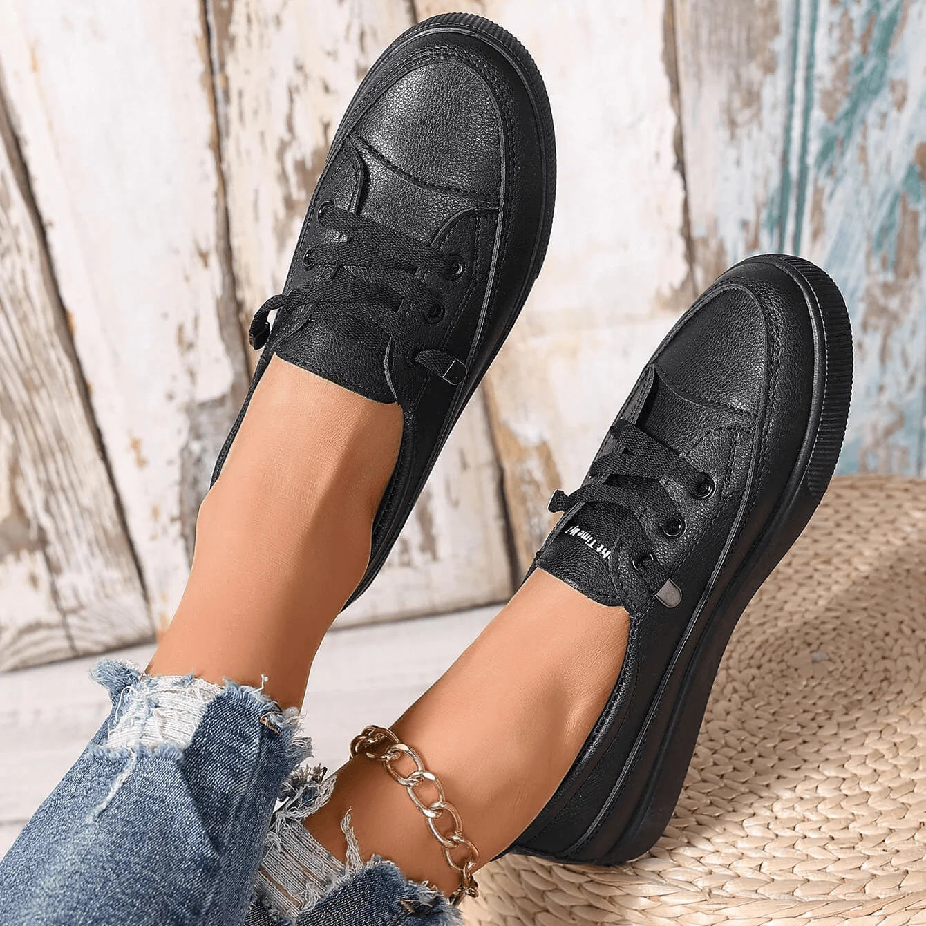 Pair of white lace-up trainers styled with casual denim for relaxed weekend wear