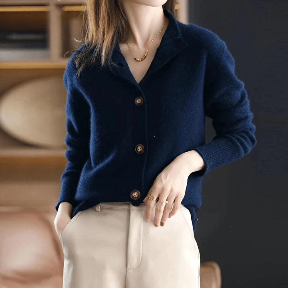 Close-up of fold-over collar and button closure on women's knit cardigan