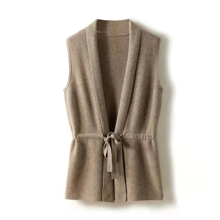 Model in the beige cashmere vest layered over a fitted black turtleneck