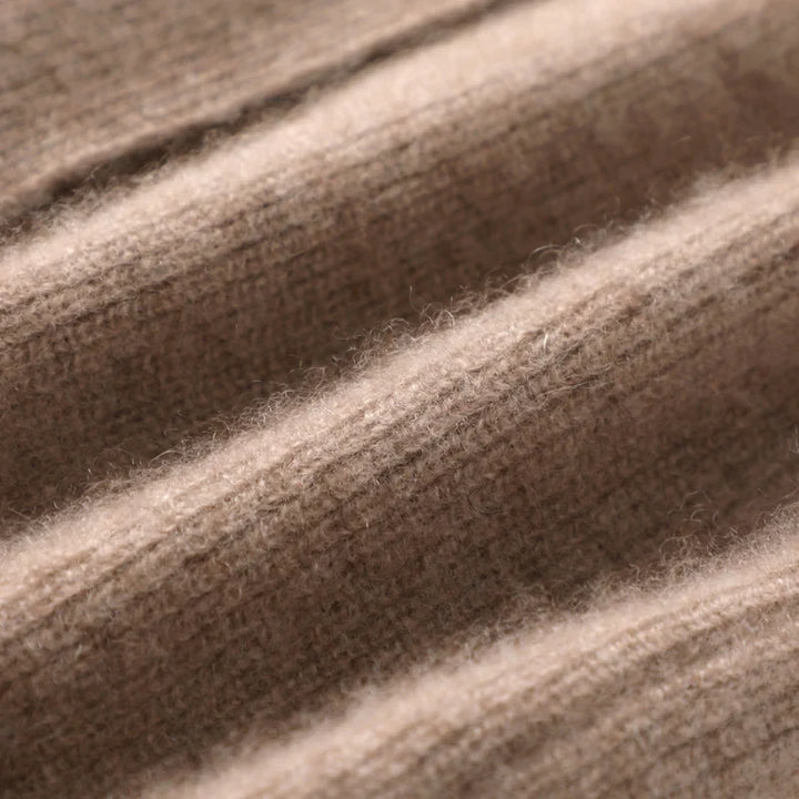 Close-up of the open front neckline and soft knit construction on the vest