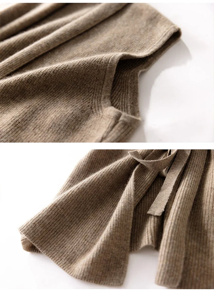 Model in the cashmere vest layered over a long-sleeve top and tailored trousers