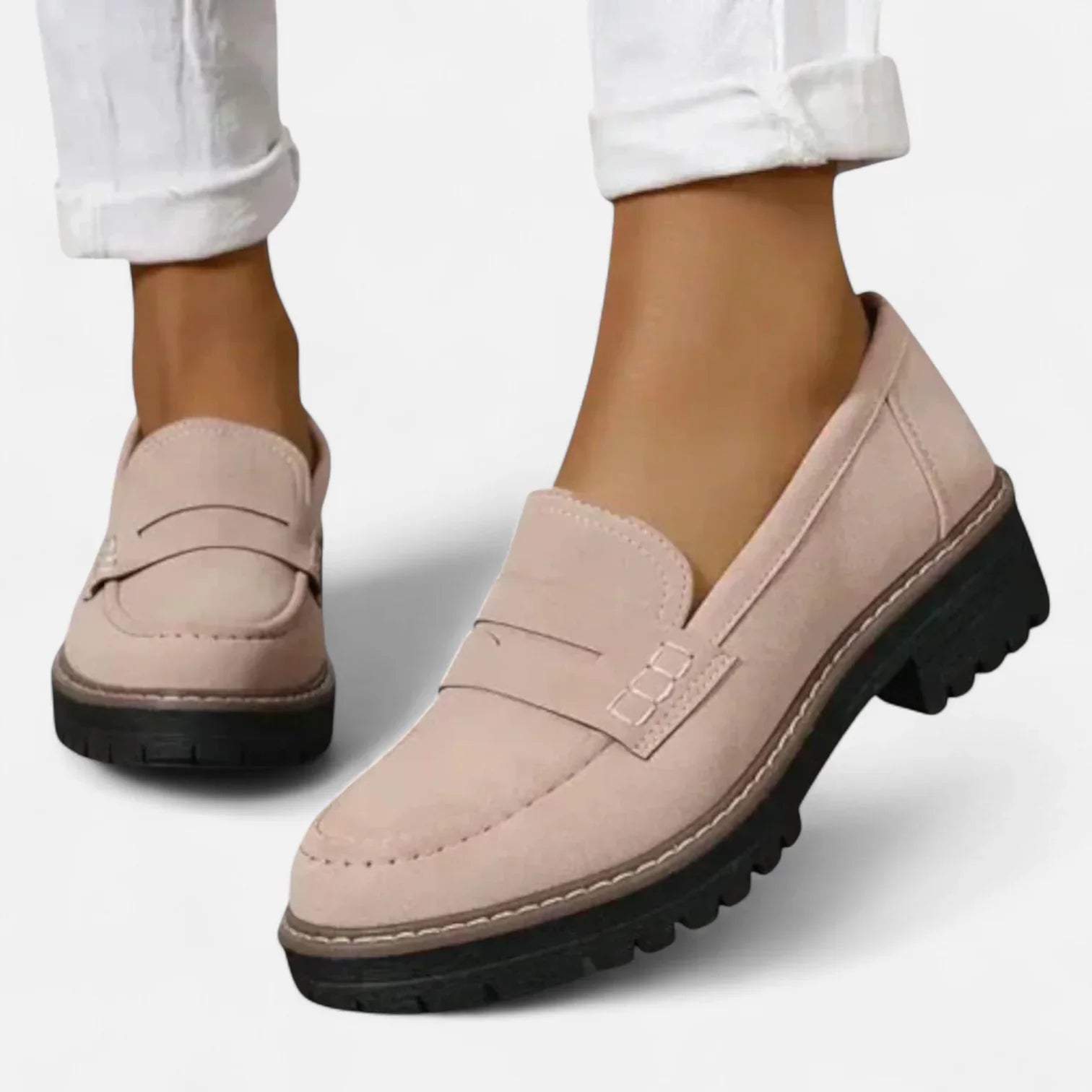 Close-up view of women's black chunky loafers showing tonal strap detail and contrast stitching