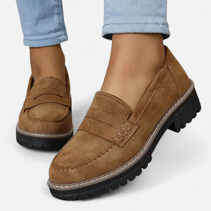 Detail shot of chunky loafer sole showing deep tread pattern and contrast welt stitching