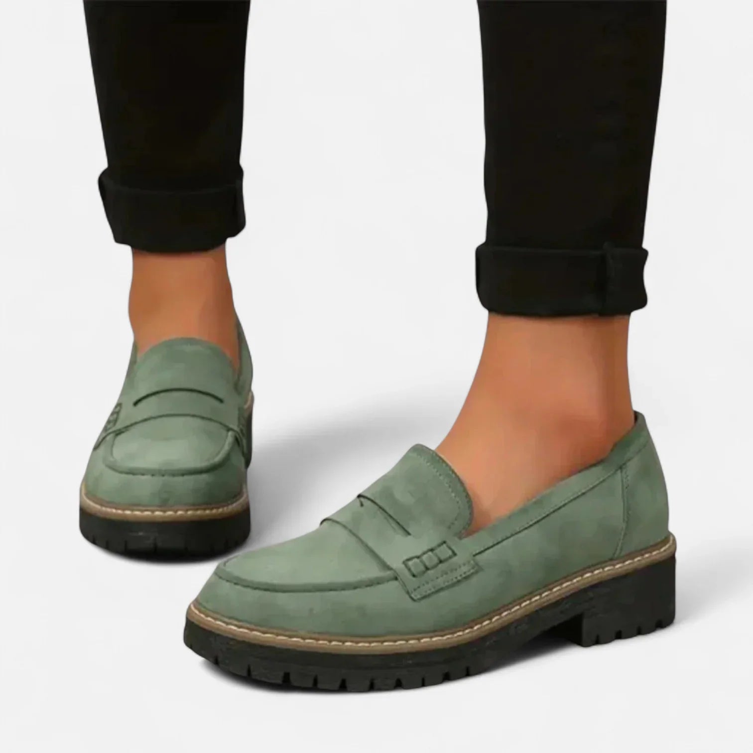 Women's black chunky loafers styled with casual trousers for everyday wear