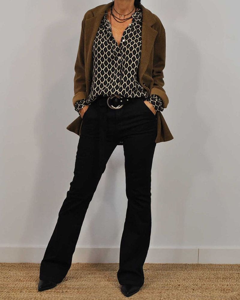 Close-up view of geometric print blouse showing ruffle collar and oversized relaxed fit