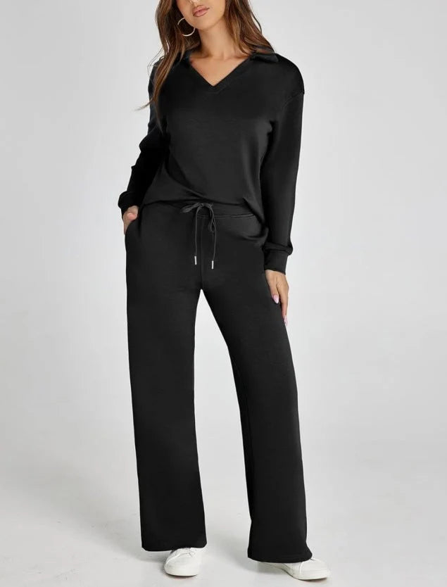 Women's lounge set in black featuring v-neck top and wide-leg trousers with drawstring waist