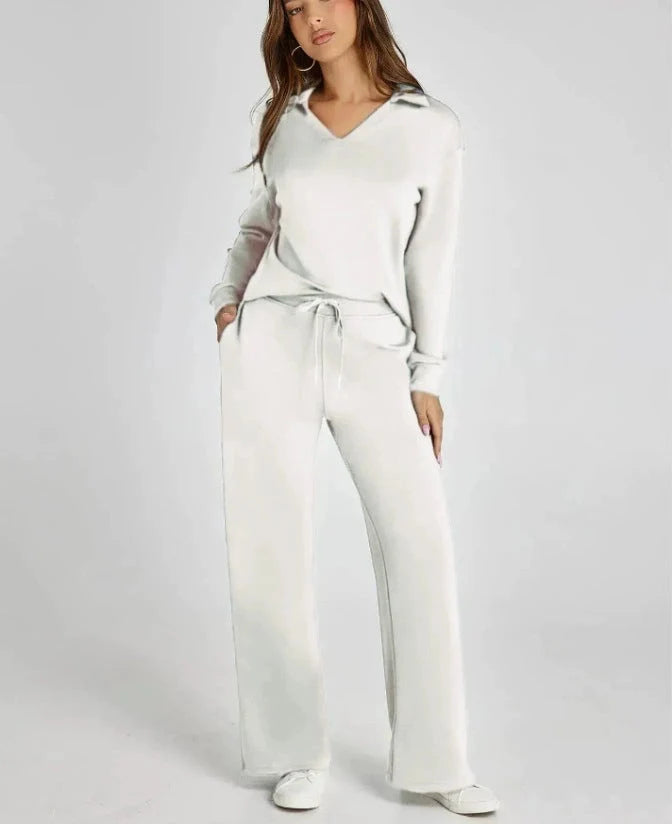 Front view of black two-piece lounge set with relaxed v-neck top and flowing wide-leg trousers
