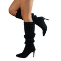 Close-up view of burgundy slouchy knee-high boots showing gathered shaft and stiletto heel detail
