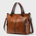 Women's structured tote bag in tan with dual front pockets and top handles
