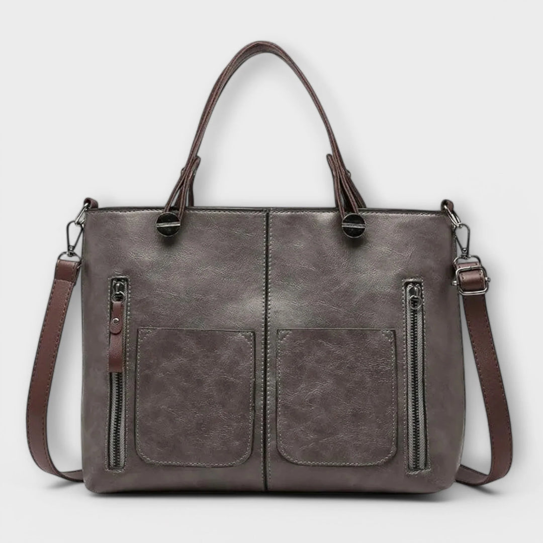 Side view showing adjustable shoulder strap and structured silhouette of women's tote