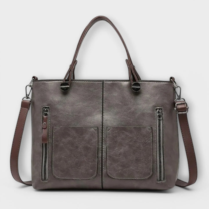 Side view showing adjustable shoulder strap and structured silhouette of women's tote
