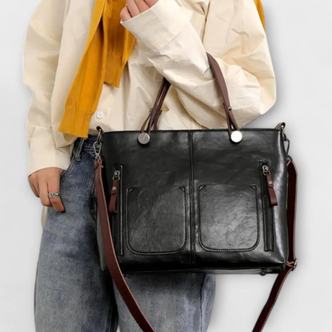 Detail shot of metal hardware and zip fastenings on structured tote bag