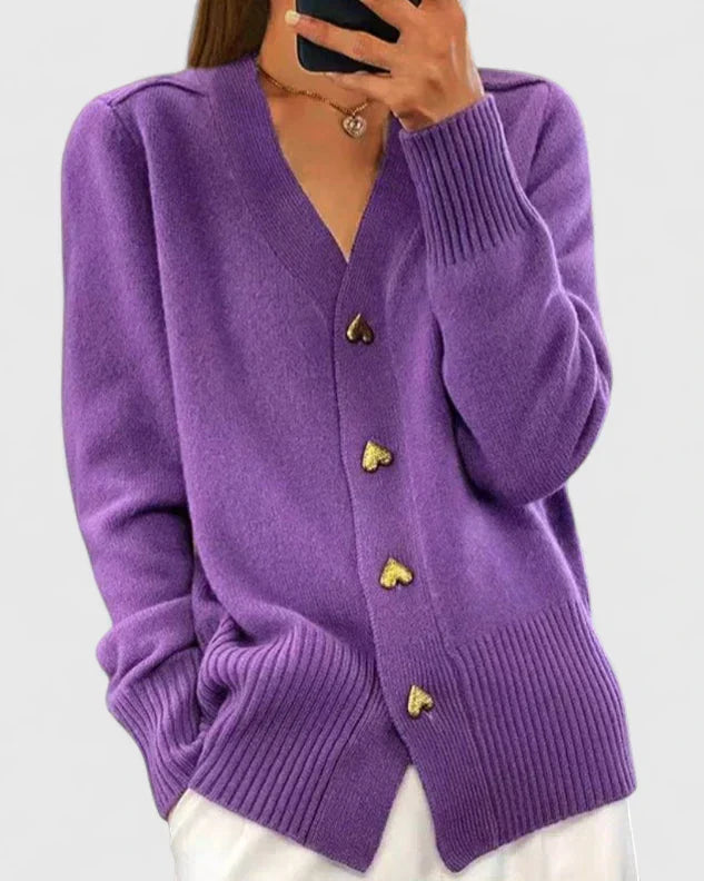 Side view of women's V-neck cardigan with heart button detail