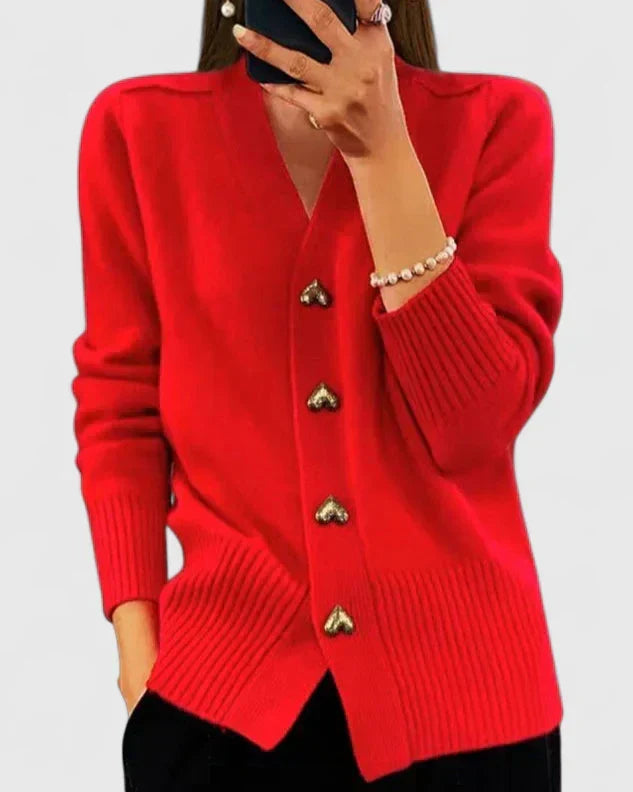 Women's navy cardigan styled with cream trousers for layered look