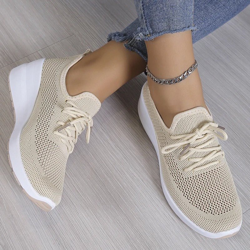 Close-up view of women's knit trainers showing structured knit upper and lace-up detail