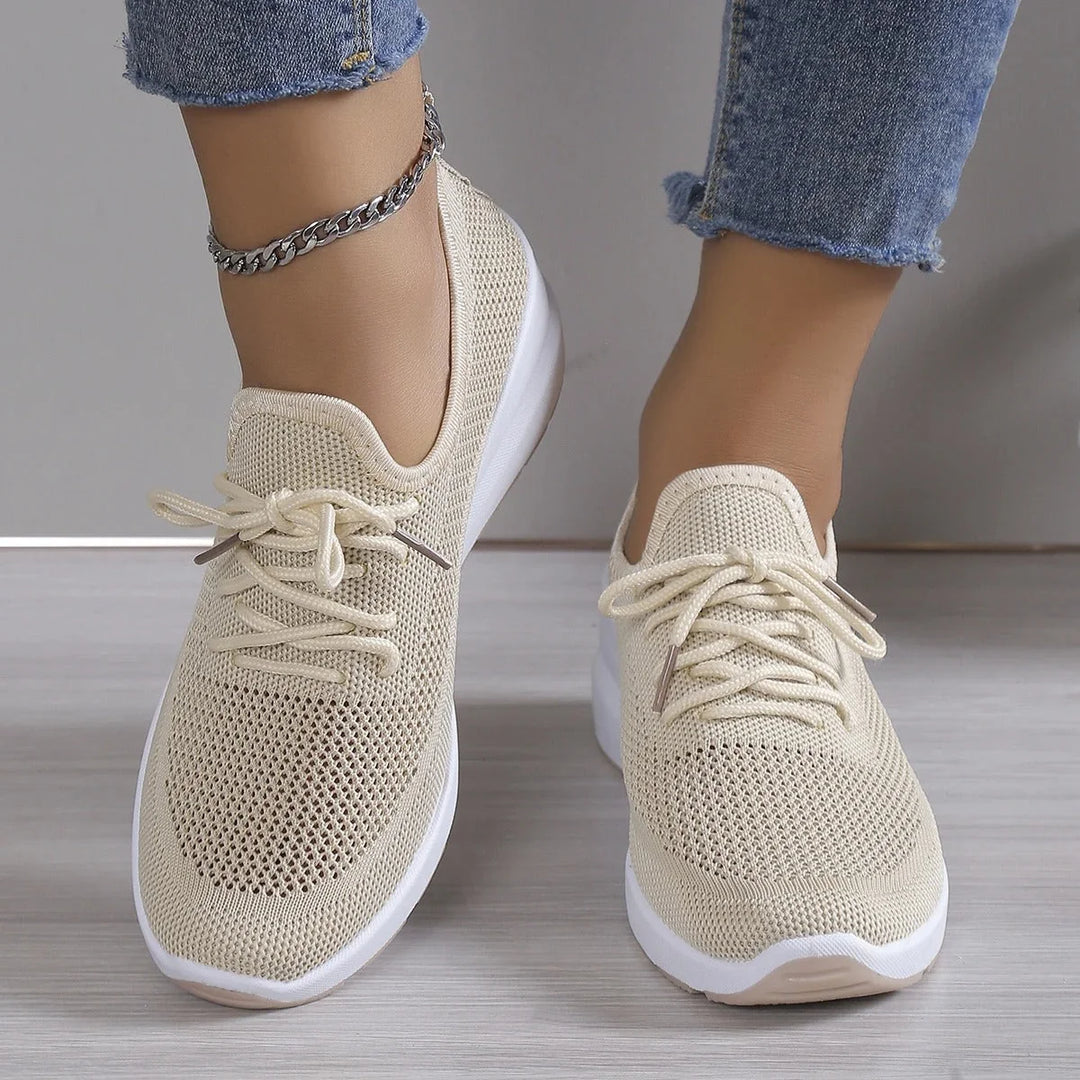 Side profile of women's knit trainers displaying chunky cushioned sole and slip-on design