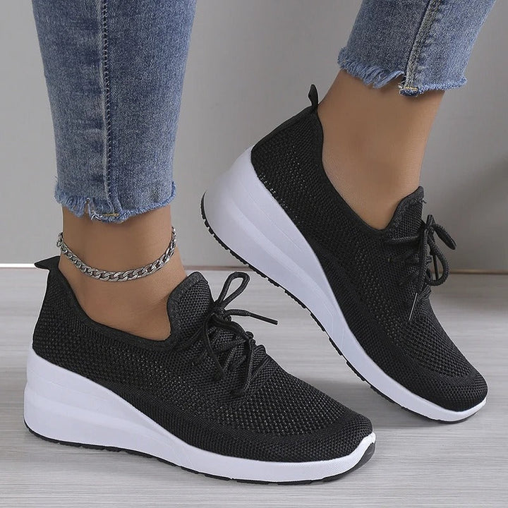 Detail of women's knit trainers featuring elastic collar and smooth knit finish