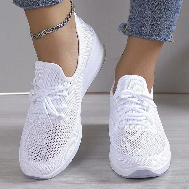 Women's knit trainers from above showing lace-up closure and rounded toe shape
