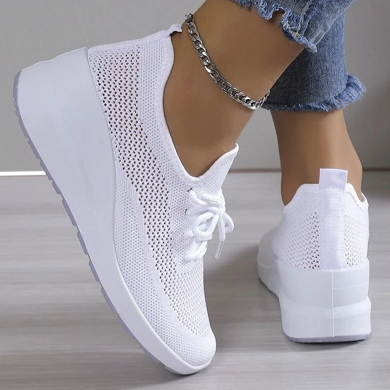 Women's knit trainers on feet demonstrating all-day walking comfort and supportive sole
