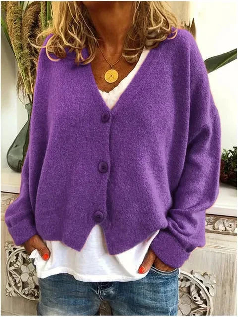 Side view of cropped cardigan paired with jeans showing hip-length silhouette