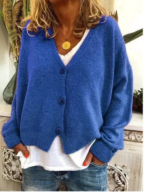 Woman styling button-front cardigan open over casual white top