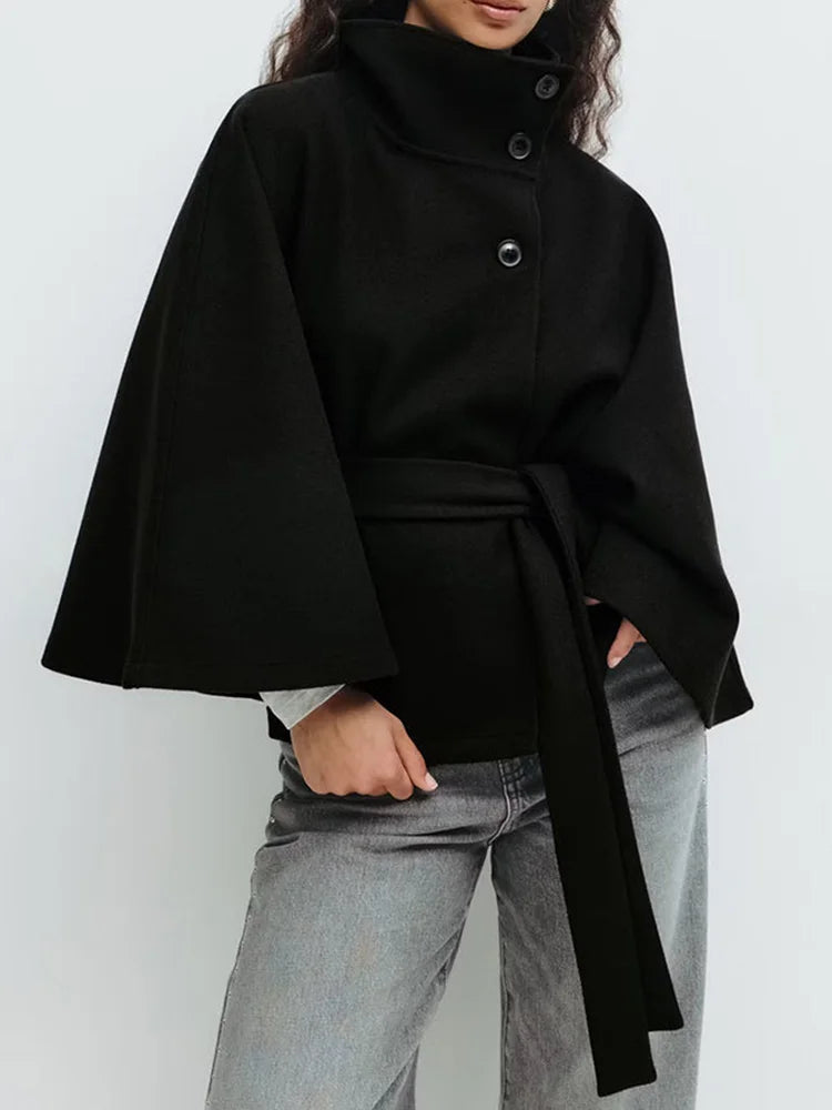 White wool cape coat displaying clean tailored lines