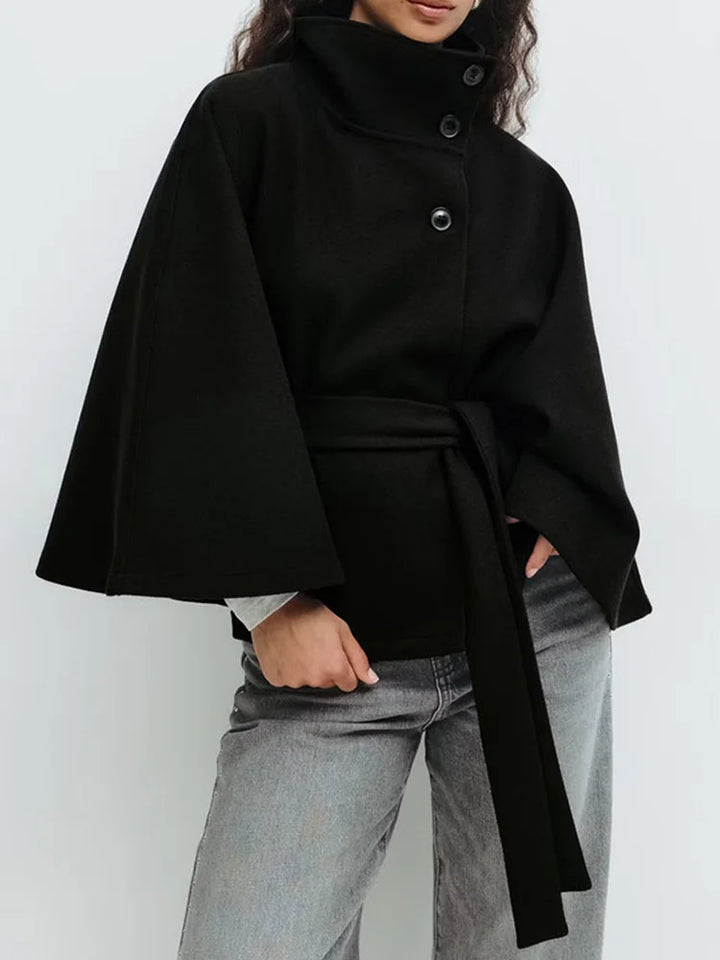 White wool cape coat displaying clean tailored lines
