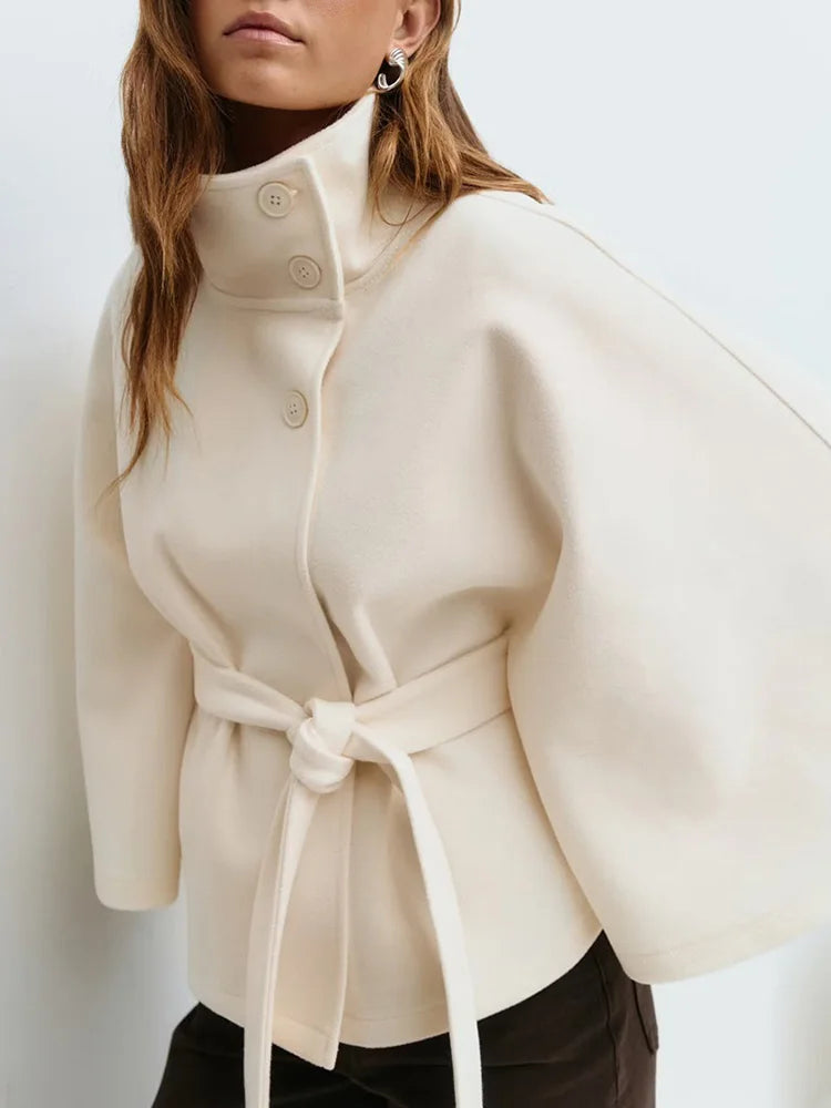Khaki wool cape coat layered over casual autumn outfit