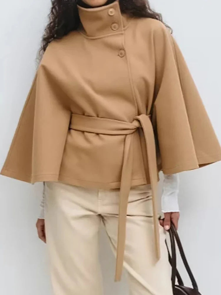 Close-up of smooth fabric finish on women's wool cape coat