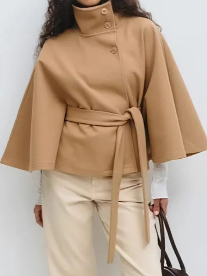 Close-up of smooth fabric finish on women's wool cape coat