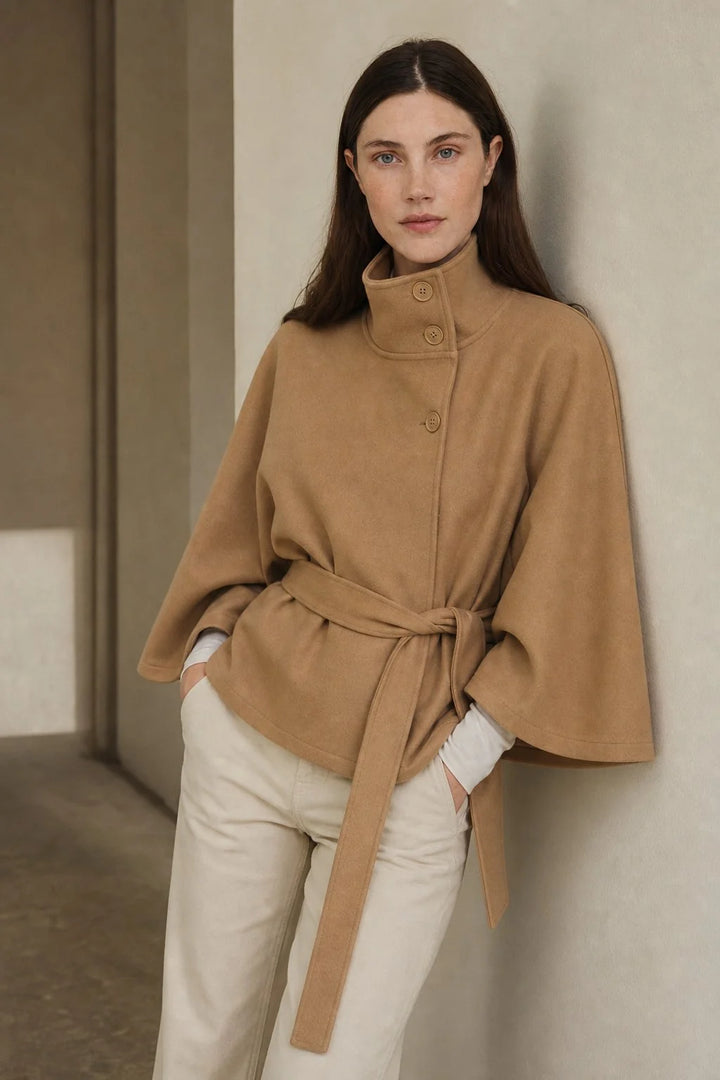 Full-length view of women's cape coat in black showing hip-length cut