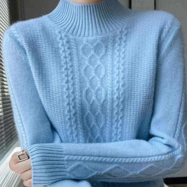 Close-up of cable knit turtleneck jumper showing raised knit detail and relaxed fit