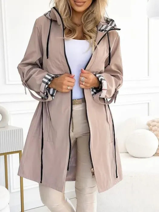 Close-up of women's hooded zip coat showing contrast check-print lining and adjustable drawstring hood