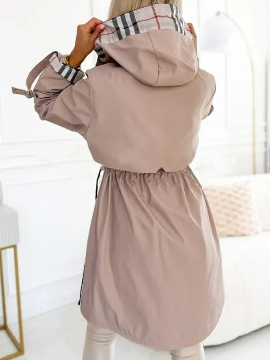 Side view of women's mid-length hooded coat with relaxed fit and structured fabric
