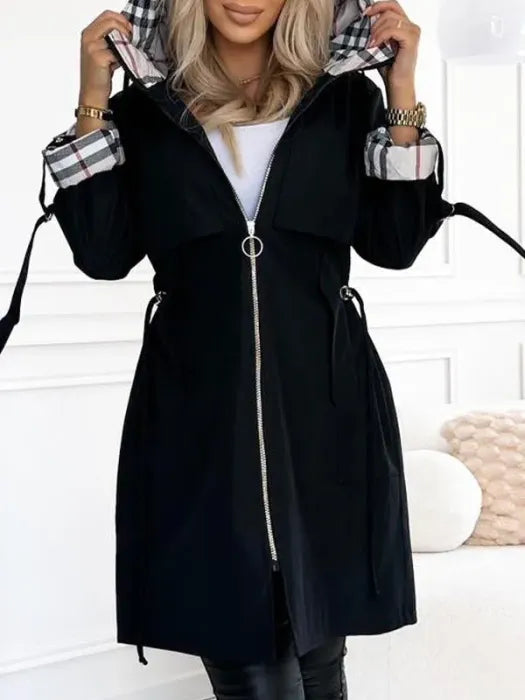 Detail view of women's hooded coat featuring full-length zip fastening and patch pockets