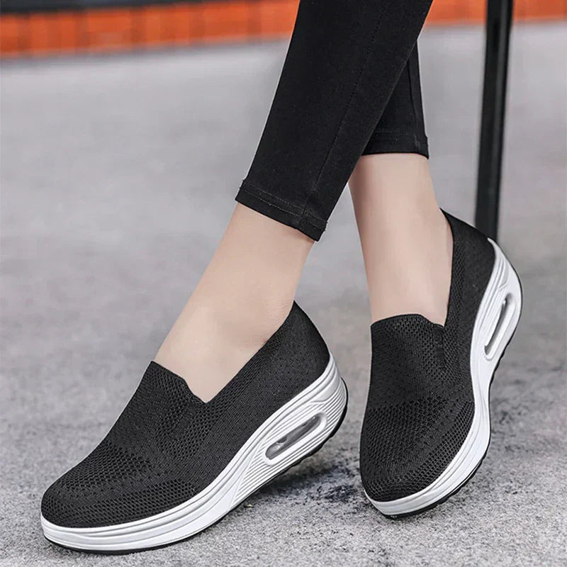 Women's mesh platform trainers in black with white air sole and slip-on design