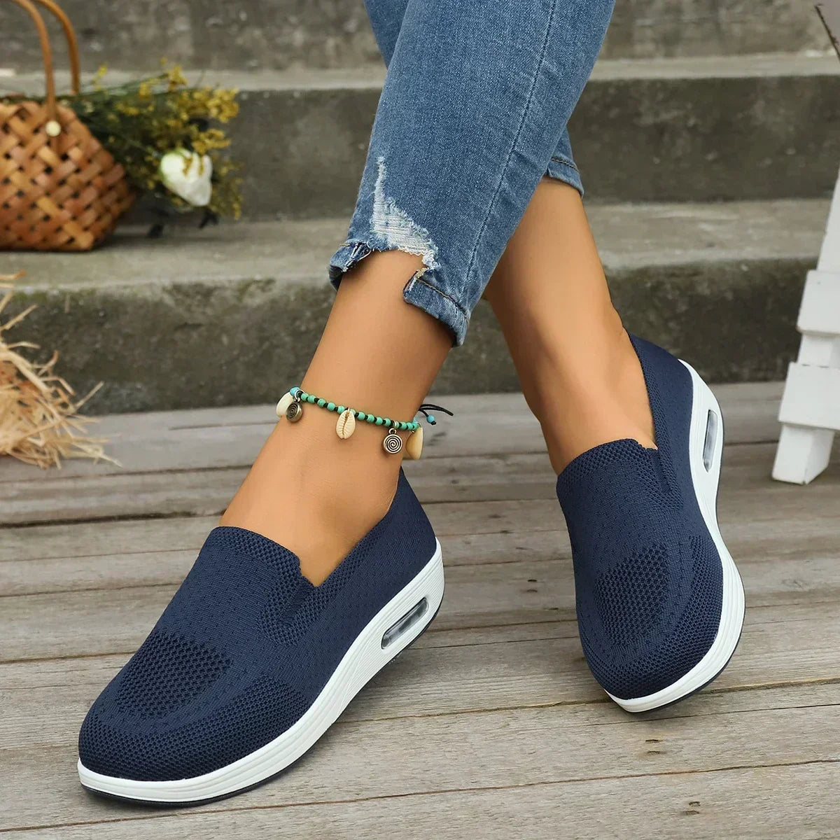 White mesh platform trainers showing textured knit fabric and air cushion sole
